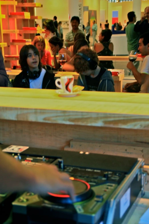 two people are playing with record player and drink