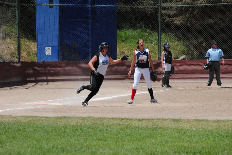 a baseball player chasing after the base