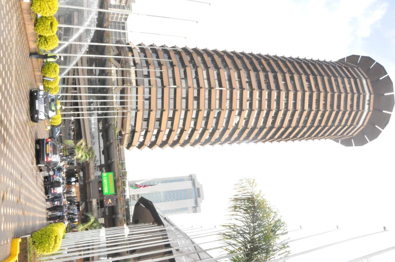 some cars are parked in front of a tall building