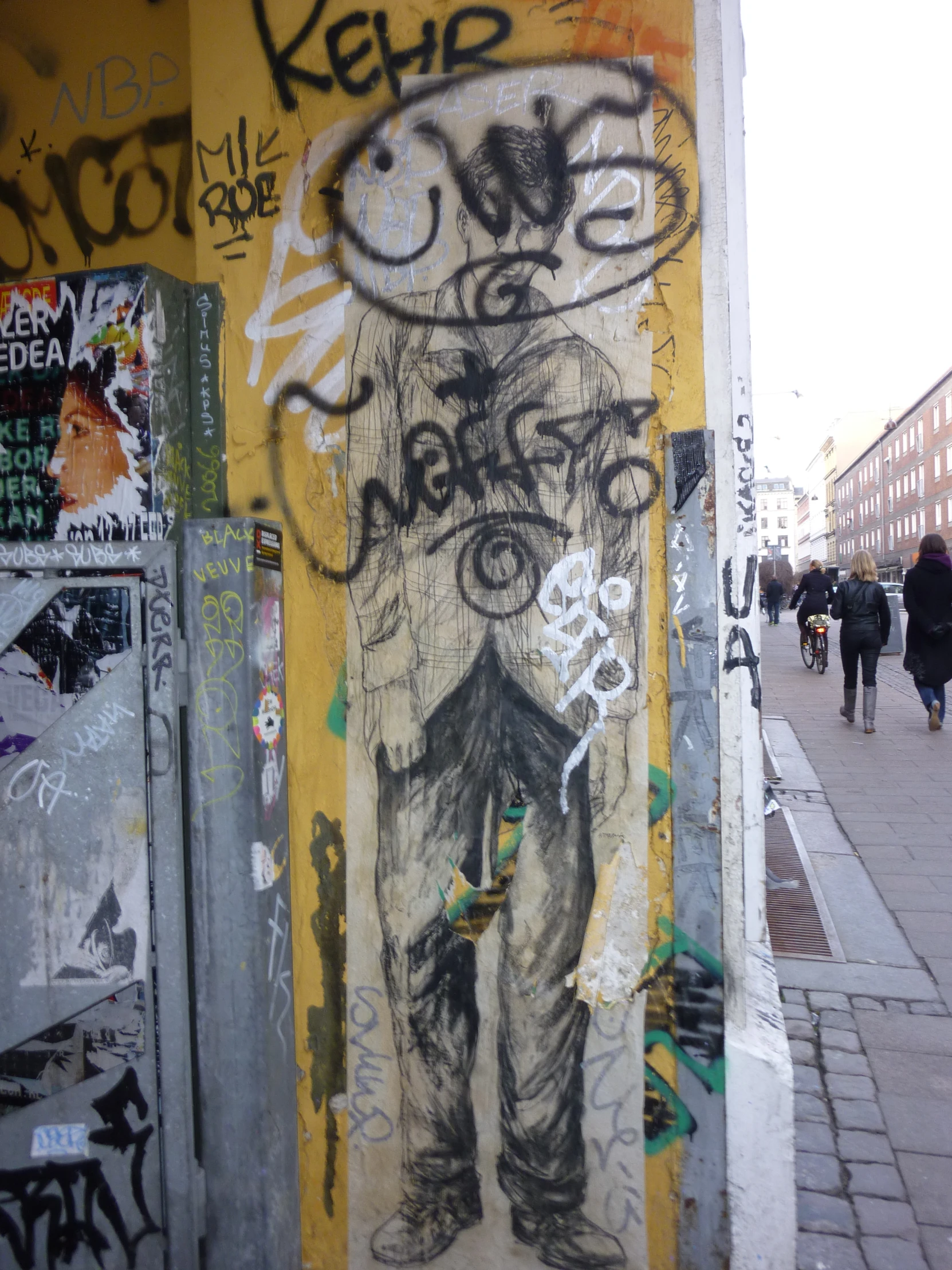 a door covered in graffiti and street signs