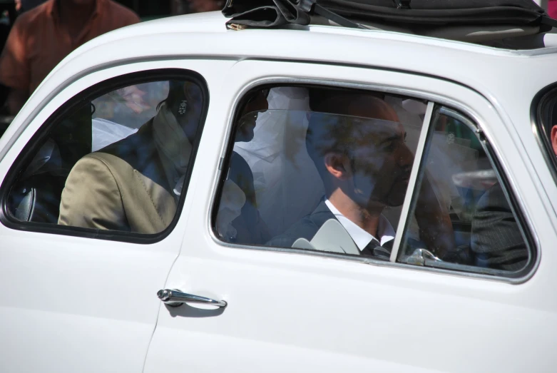 a man in suit is in his car