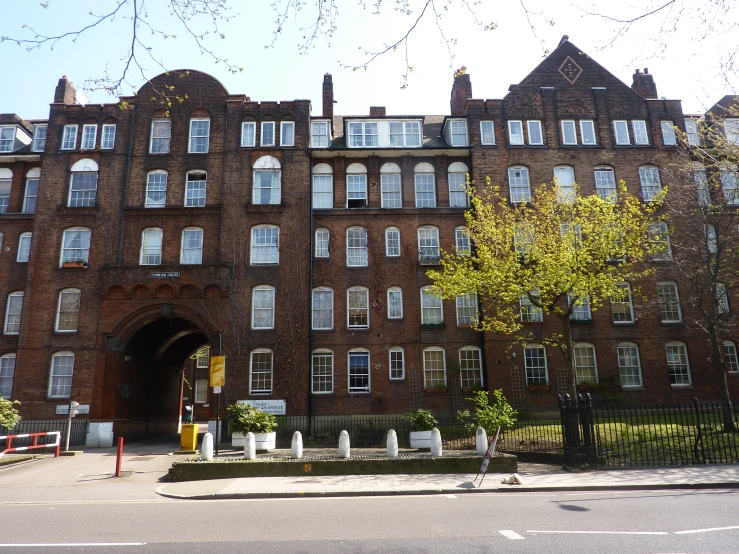 a building with many windows, on the corner of a street