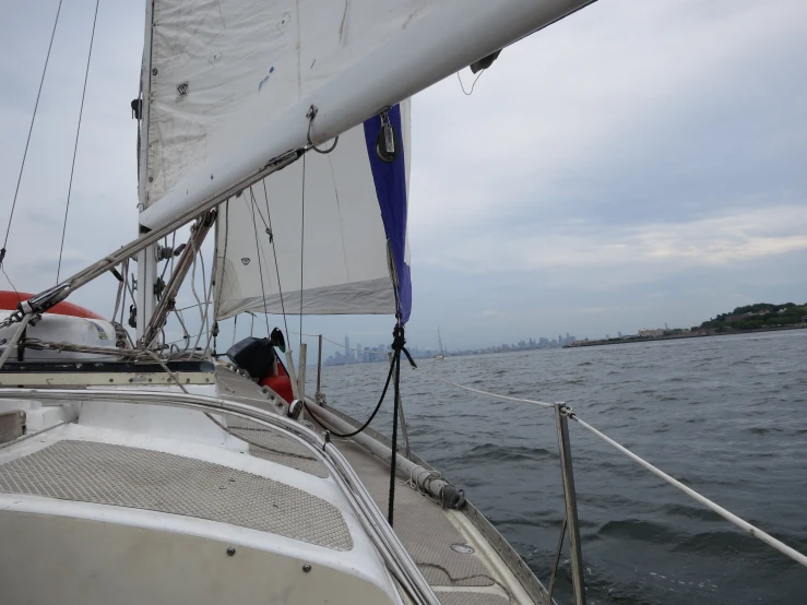 a white sailboat floating in the ocean next to another sail boat