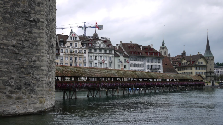 people walk across a bridge in the middle of a river