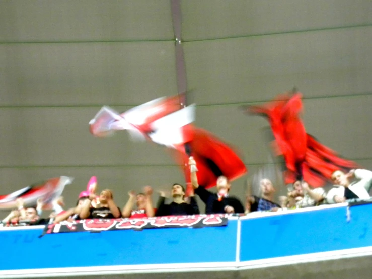 a crowd of people standing in front of a big screen