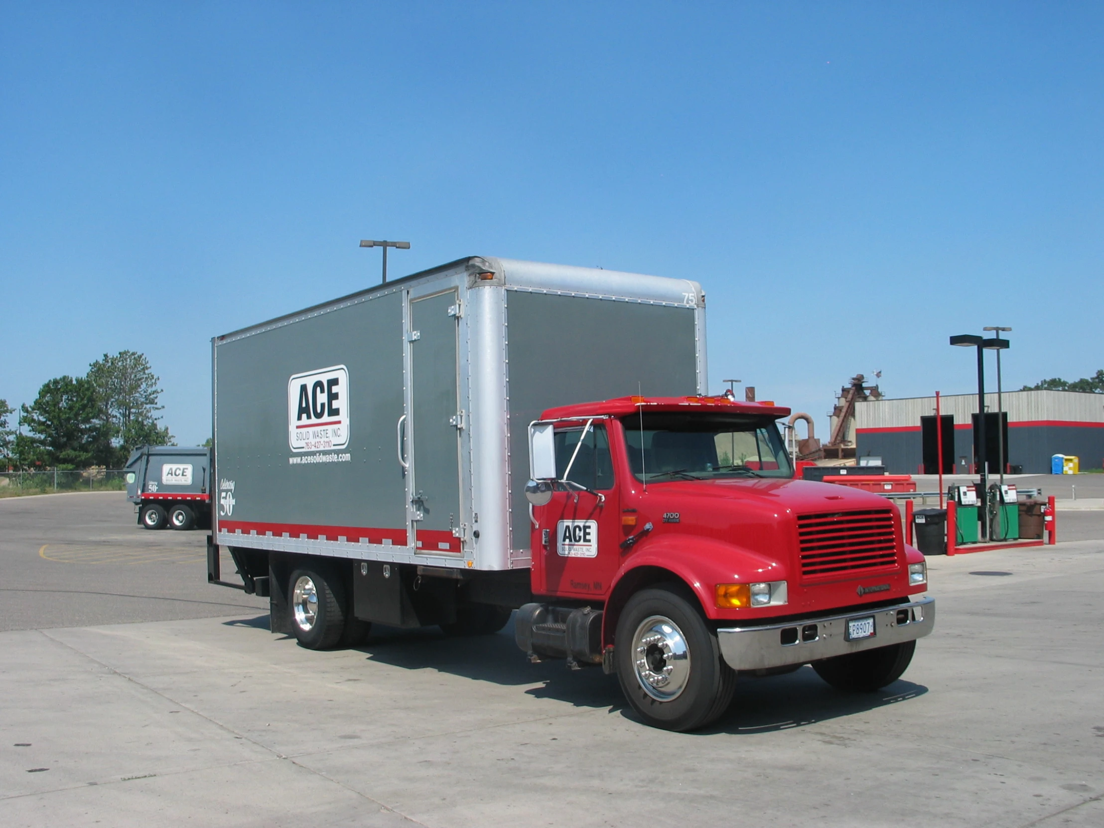 a big semi truck driving past a gas station