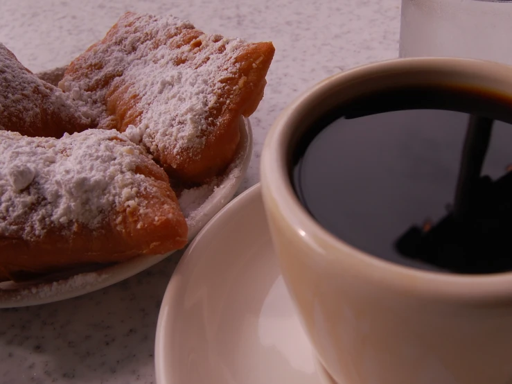 coffee and three pastries are sitting on the table