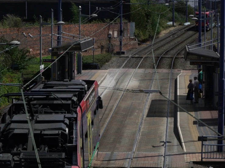 two people are walking on the train tracks