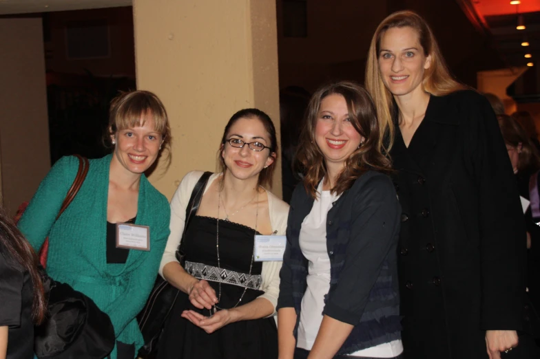 some women are standing together at an event