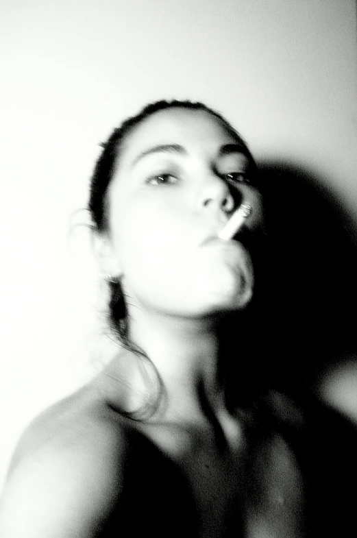 a black and white po of a woman blowing a cigarette