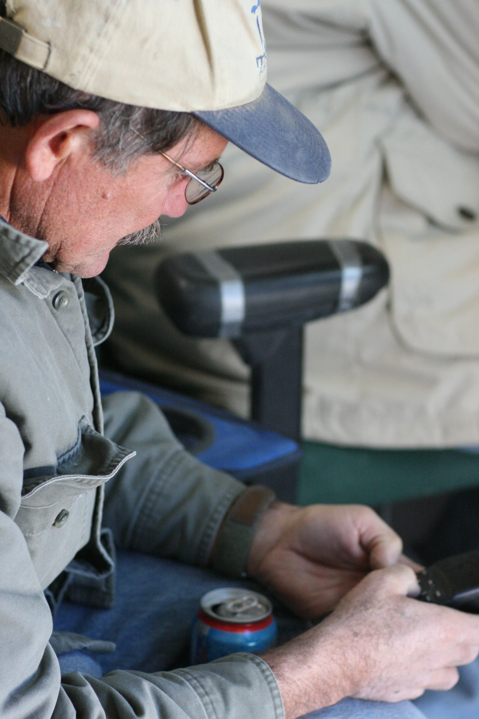 an older man uses his cellphone while sitting down