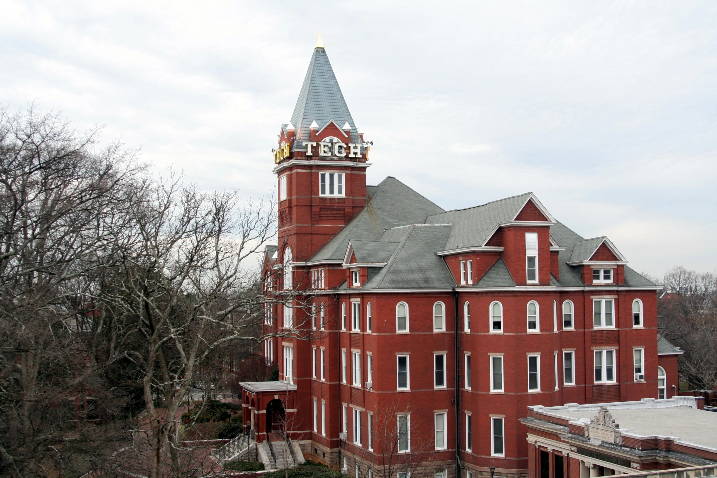 an old red brick building with a large tower