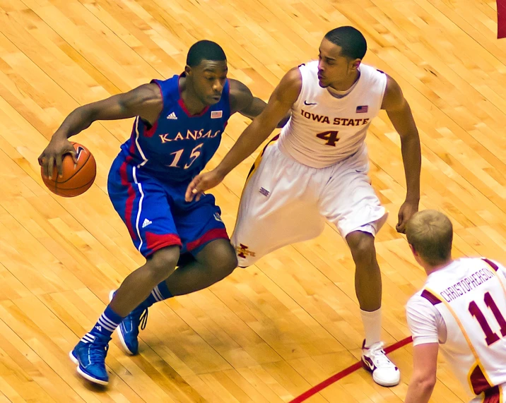 two players are going after a basketball in the court