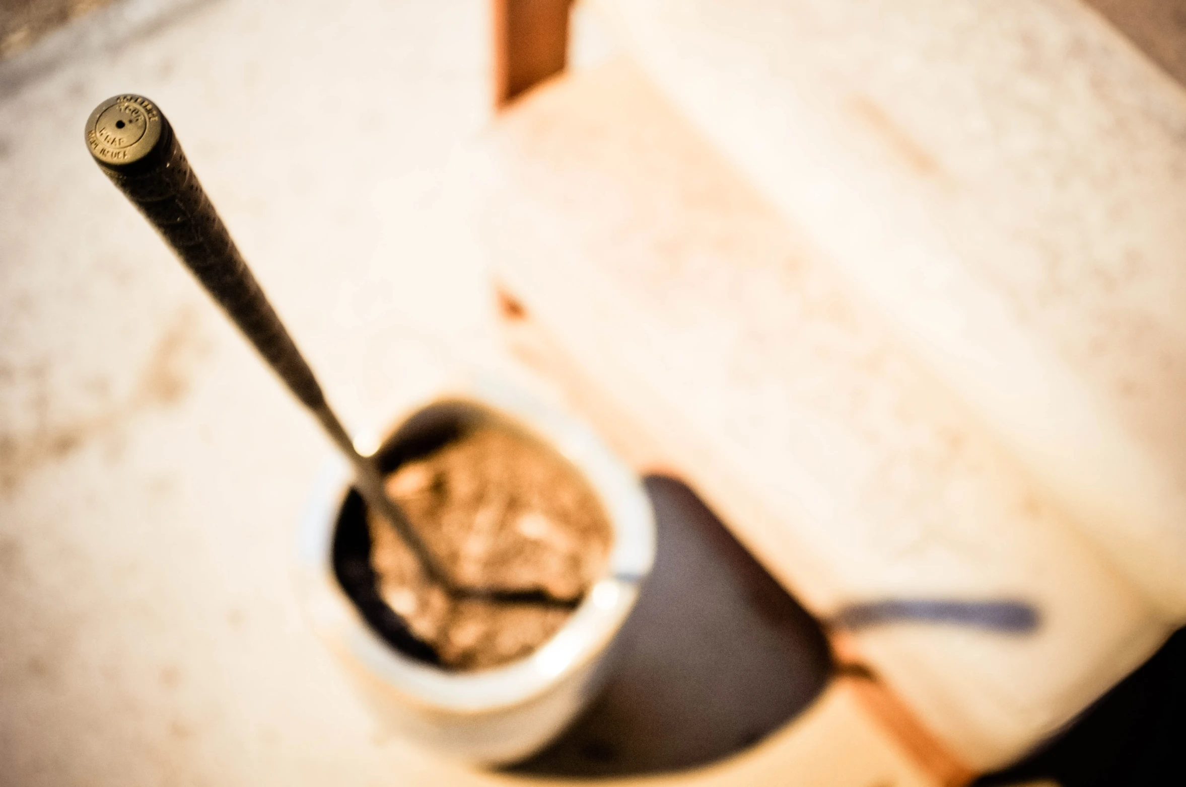 a spoon sitting in a small cup with food