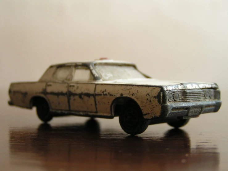an old model white and black car with stains on it