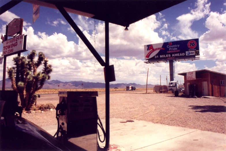 the building has a gas pump and some signs