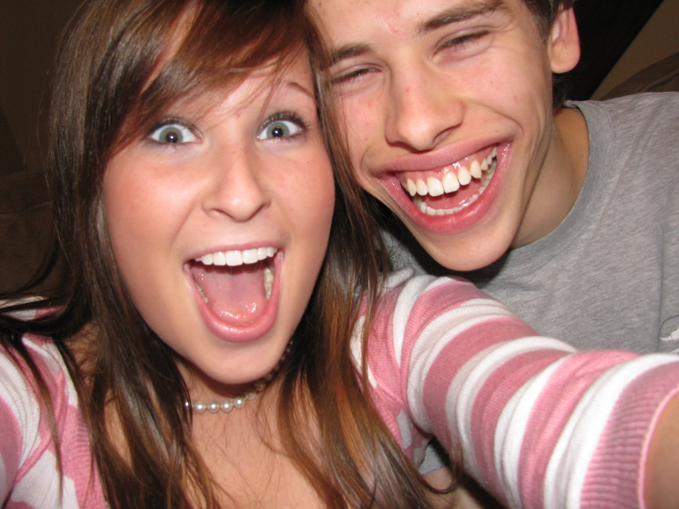 a young man and woman taking a selfie with one girl in a pink  shirt