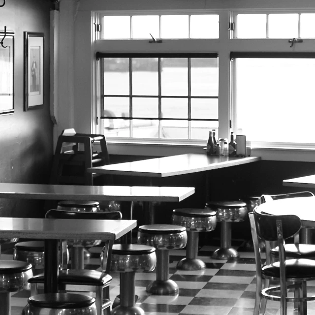 an empty diner with checkered tile floors