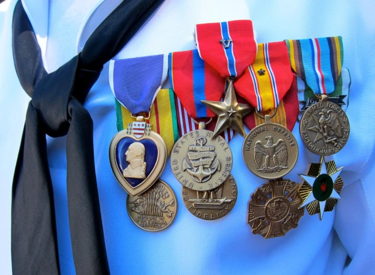 an army man wears medals from all sides