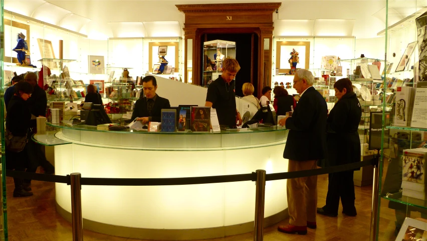 people are gathered around the counter in a store