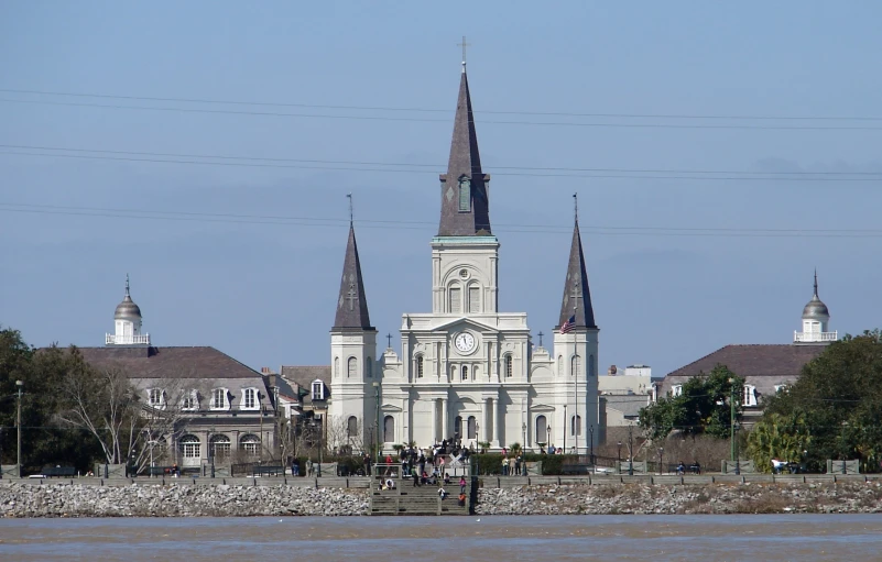 a church with steeples and people on a dock