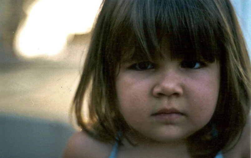 a close up of a little girl with  on