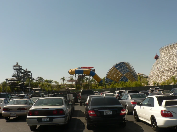 many cars and roller coasters and an amut park