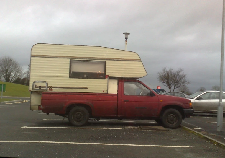 an older style truck is parked in a lot