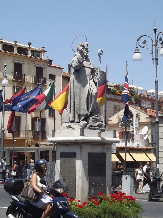 a motorcycle parked in front of a statue