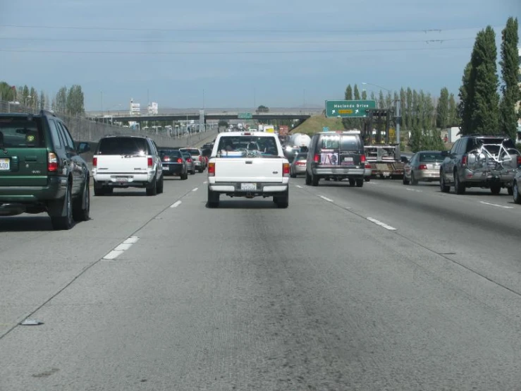 a view of several vehicles traveling down a busy freeway