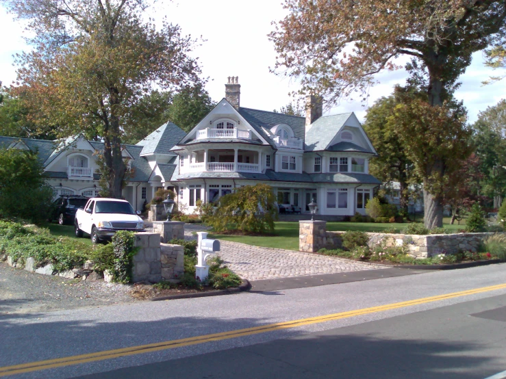 a beautiful white car parked in front of a house