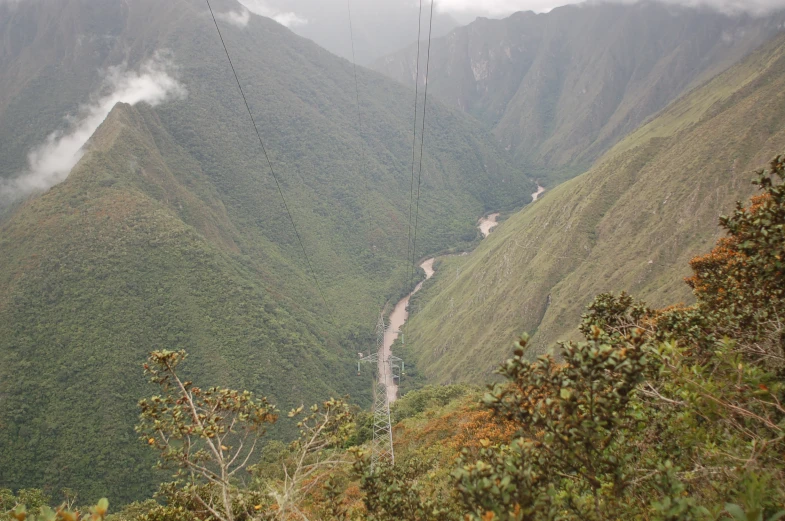 looking down into the valley below from an overhead cable