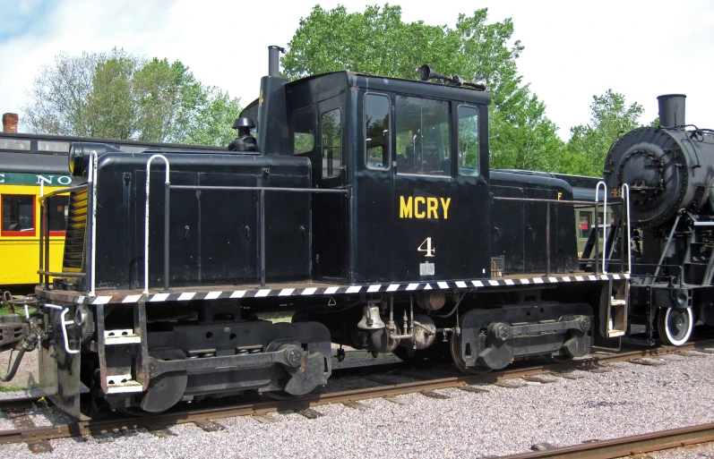 a black and yellow train engine is on the tracks