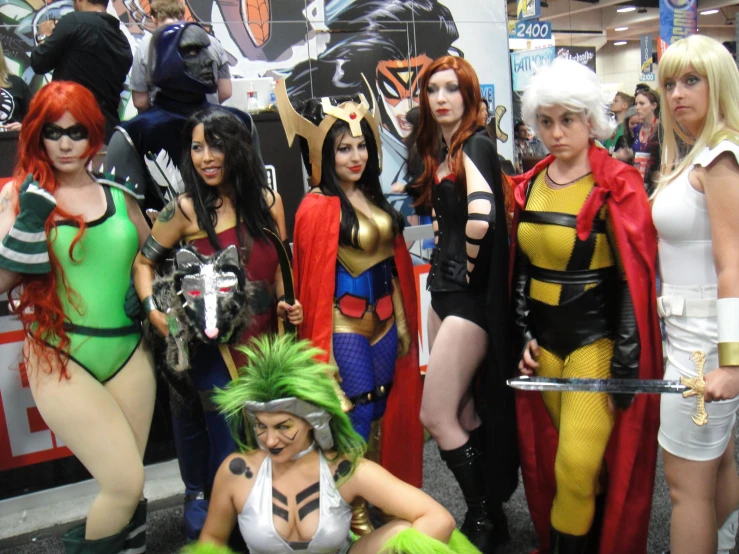 group of women dressed as comic characters posing for a po