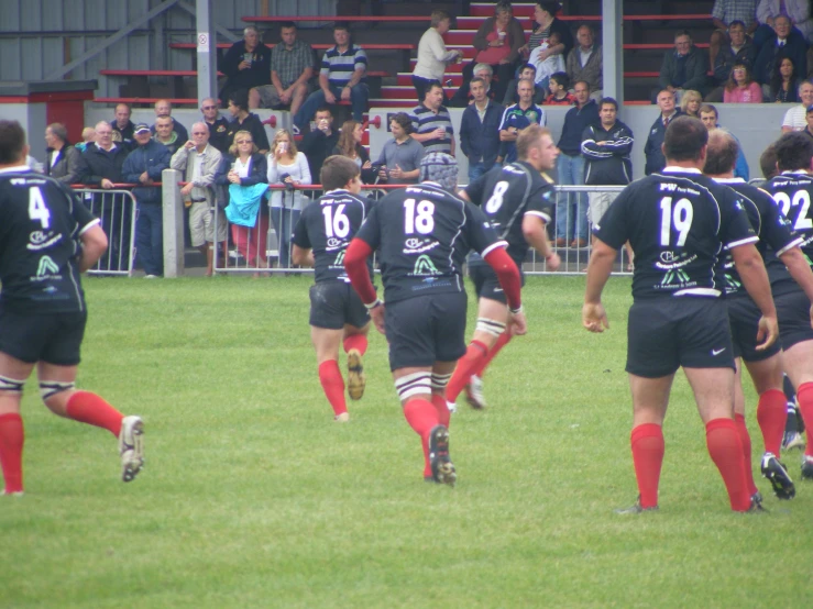 a group of men running on a field