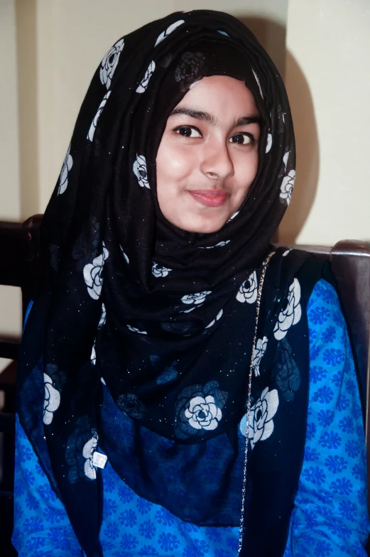 a woman wearing a blue and black shawl