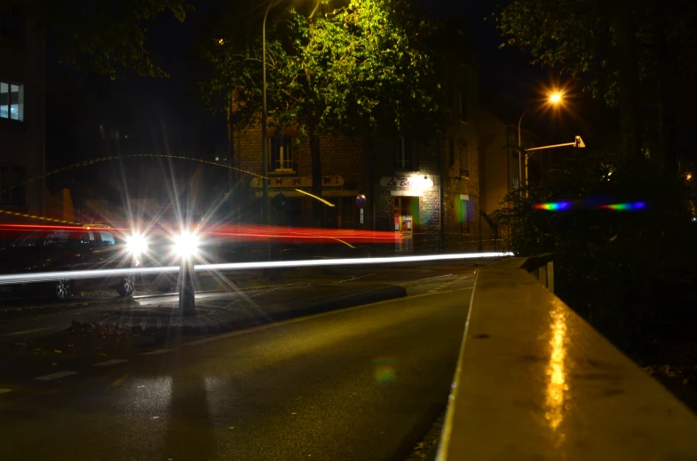 car headlights on a dark street in the evening