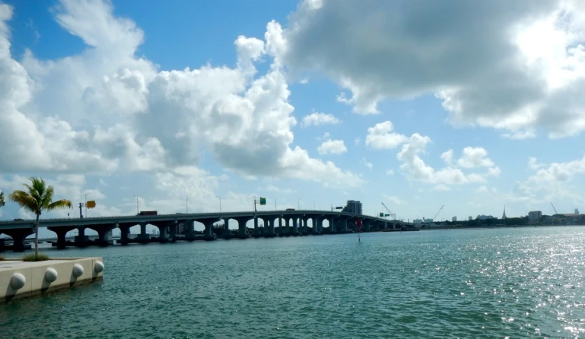 a boat traveling on the water near a bridge