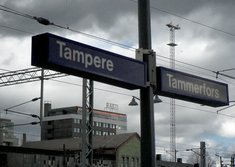 a sign that reads tampere on the side of a pole