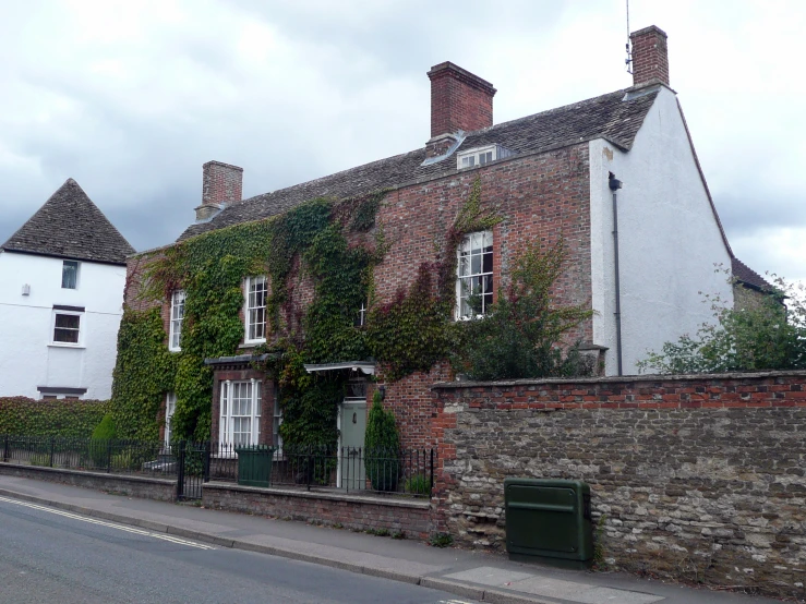 a building covered in ivy with brick walls