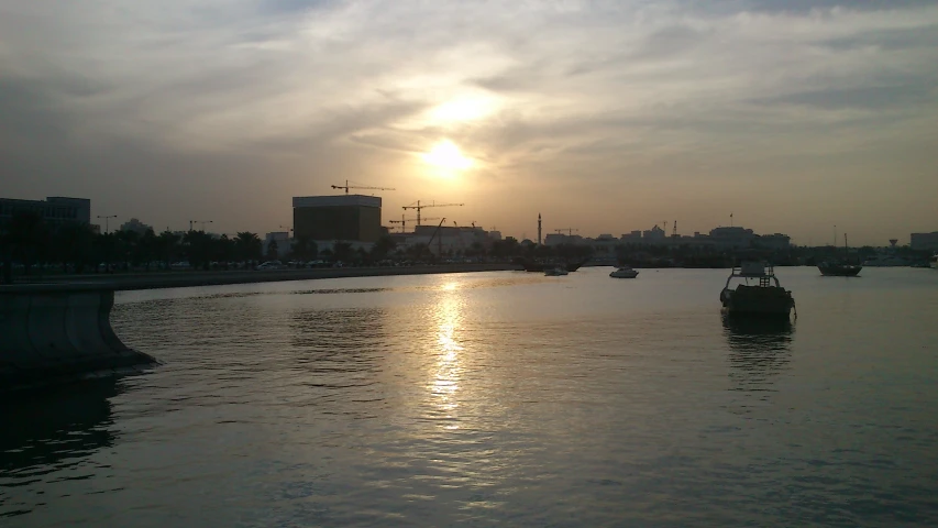 two boats out on the water at sunset