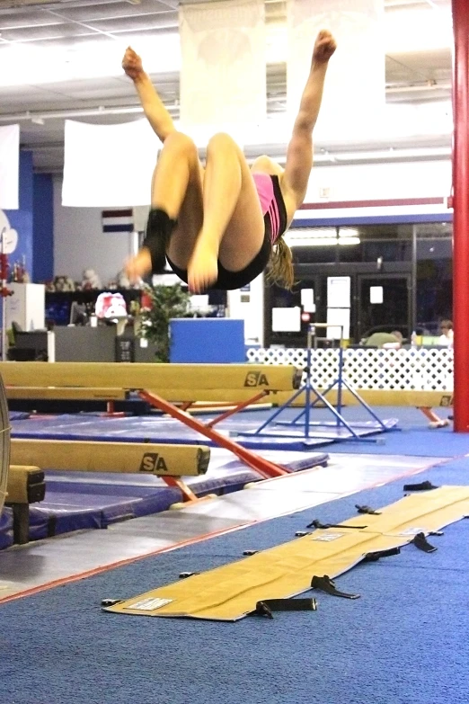 an athlete flying through the air at an indoor event