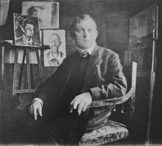 an old man sitting in front of an easel in a room