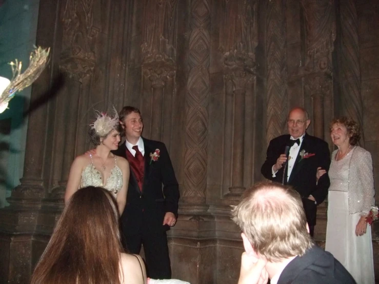 bride and groom are on stage during their wedding ceremony