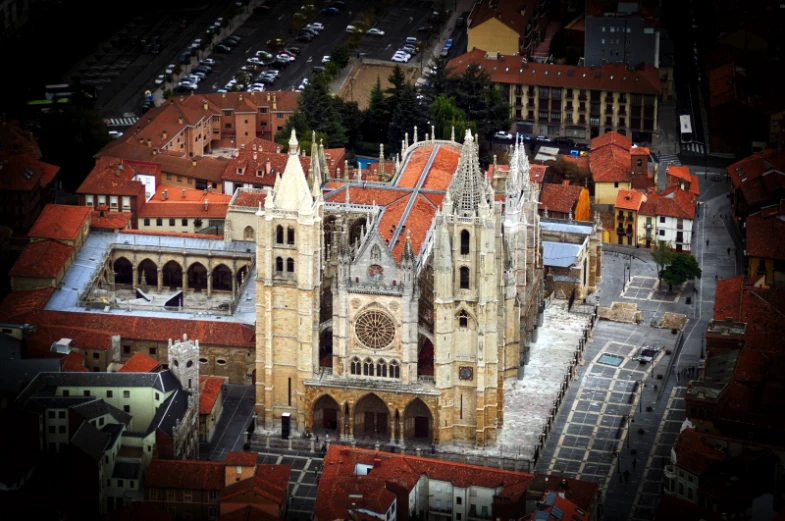 a building with a cathedral on the top that has orange rooftoping