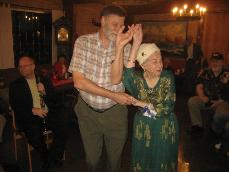 an older woman dancing with a man on stage