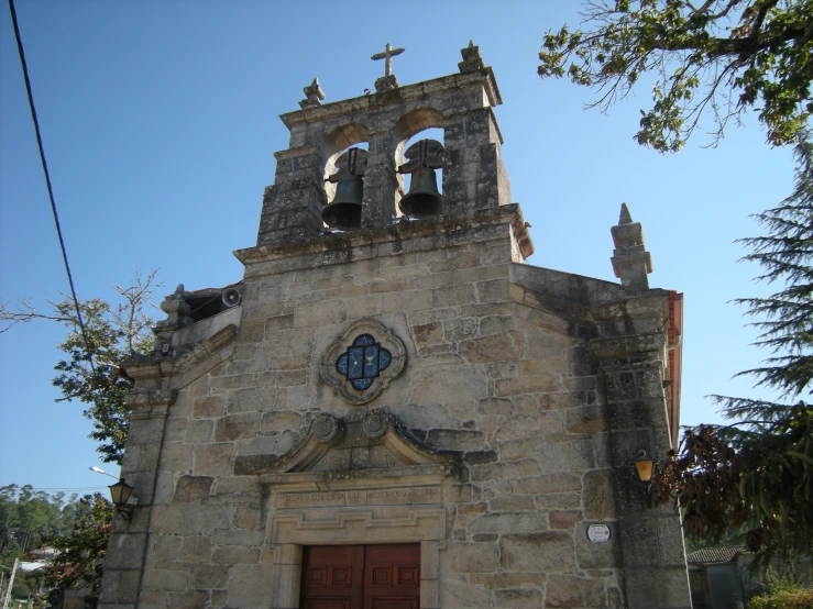 the building is very old and has a clock and bells on it