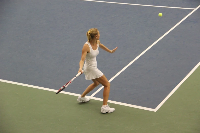 a tennis player hitting the ball while standing on the court