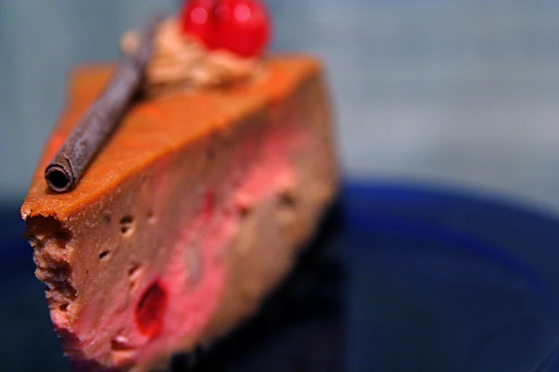 closeup of a piece of cheesecake with cherries on top