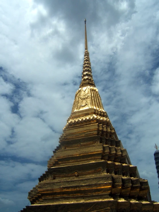 a golden buddha statue on the side of a building